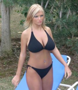 Sexy full breasted blonde in black bikini outdoors